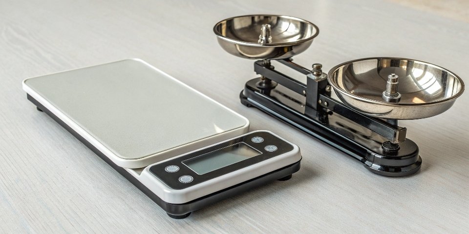Digital vs Manual Scale Accuracy An image comparing a sleek digital scale and an old-fashioned manual scale