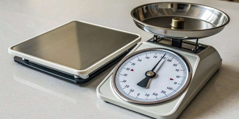 Analog and Digital Weighing Scales An analog scale and a digital scale side-by-side