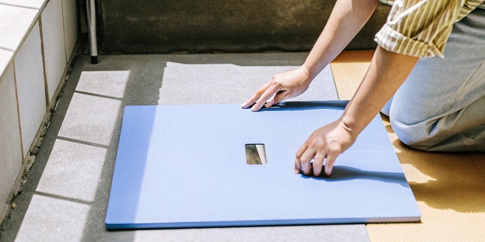 Proper Scale Placement A person checking if a weighing scale is level on the floor.