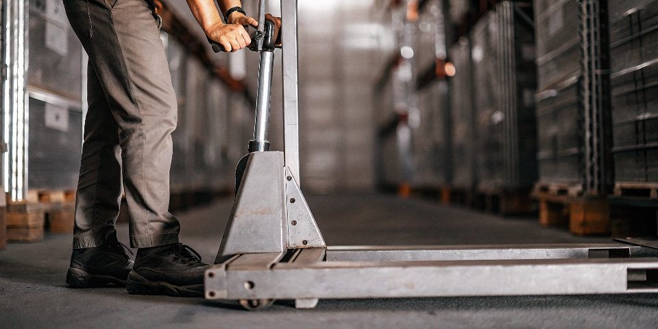 Industrial Weighing Application A worker using a platform scale in a warehouse setting