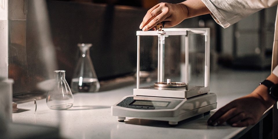 Digital Scale Accuracy in a Lab A laboratory technician using a high-precision digital scale