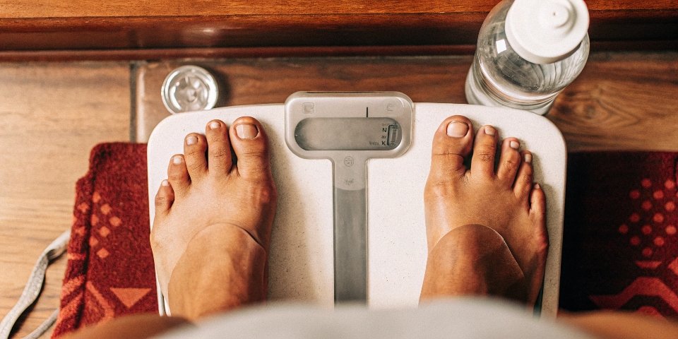 Everyday items like a coin and a bottle of water on a digital scale