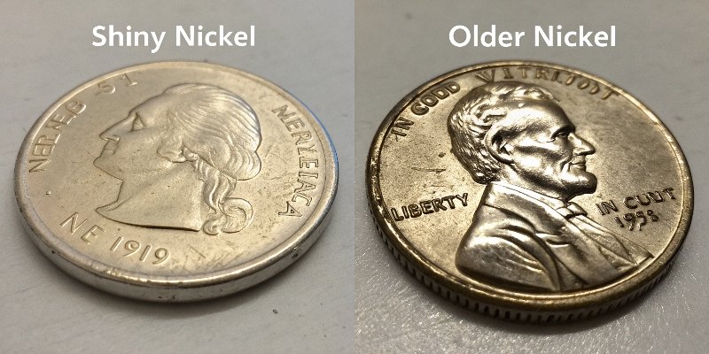 New vs Old Coin Comparison A picture comparing a shiny new nickel and a worn, older nickel, highlighting the visible difference.
