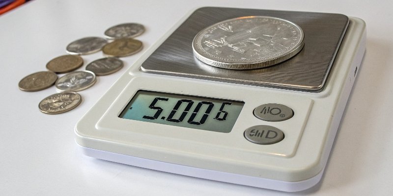 Verifying scale accuracy with a nickel A digital scale displaying '5.00g' with a single nickel on the platform