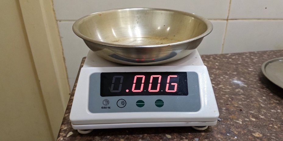 A scale display showing 0.00g after taring a container A scale with a bowl on it, with the display reading zero after the tare button was pressed