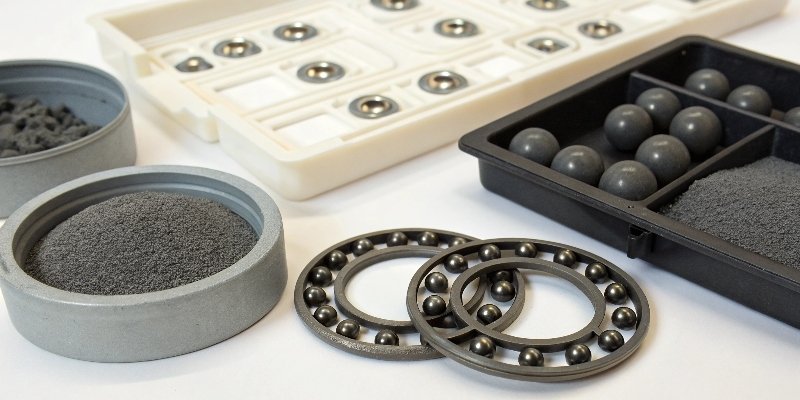 Materials for Adding Weight to Models An assortment of weighting materials like tungsten putty, lead shot, and steel bearings next to a disassembled model kit.