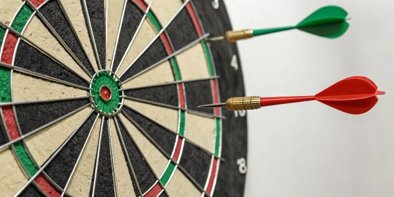 The Difference Between Accuracy and Repeatability Two dartboards side-by-side: one shows darts close to the bullseye (accuracy), the other shows darts tightly clustered but off-center (repeatability).