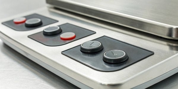 Zero and Tare Buttons on a Weighing Scale A close-up shot of the Zero and Tare buttons on an OHAUS industrial scale.