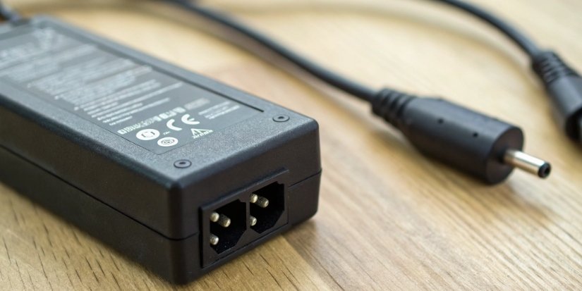 Checking power cord compatibility specifications Close-up of a power adapter's specification label