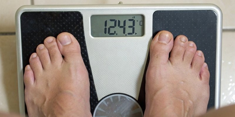 A digital scale display showing a fluctuating, unstable weight reading