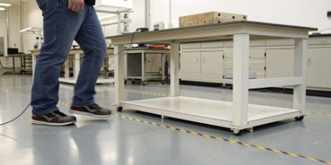 Diagram showing vibrations traveling through a floor to a regular lab bench.