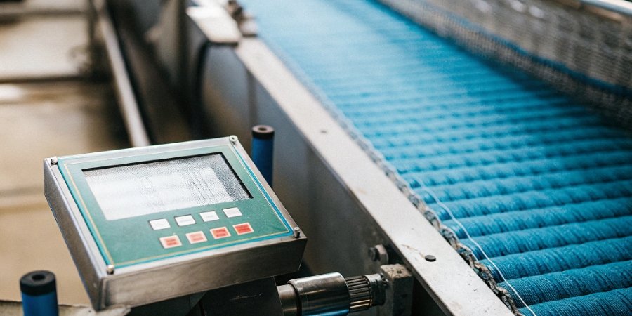 Checkweigher ensuring compliance and quality A certificate of compliance next to a checkweigher's digital display showing weight data