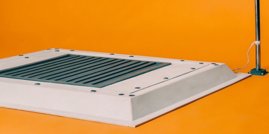 A weighbridge installation site showing drainage channels and a lightning rod nearby