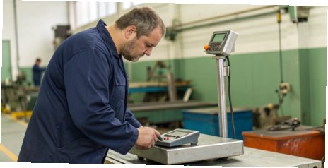 Durability and Reliability Testing of Scales A quality inspection technician testing the durability of an industrial digital scale
