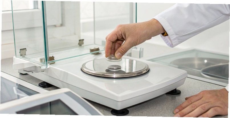How to balance and level a lab scale A close-up view of a leveling bubble on a lab scale, with a hand adjusting the foot