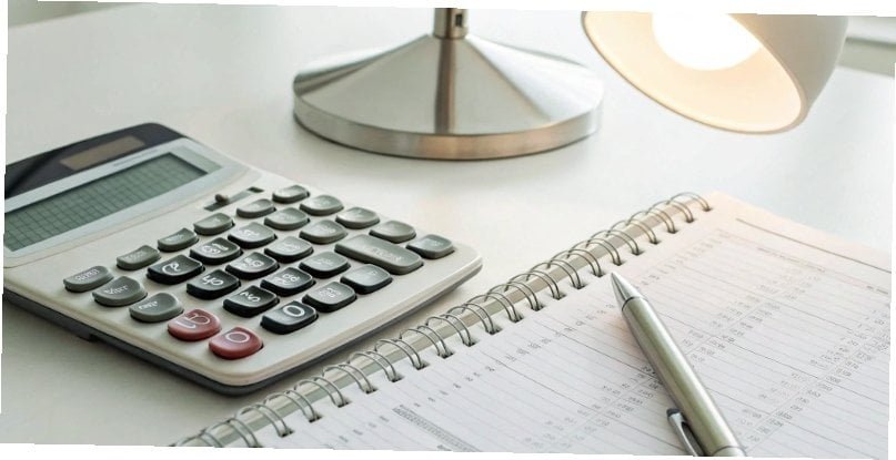 A calculator and a notepad showing a cost-benefit analysis for repairing equipment.