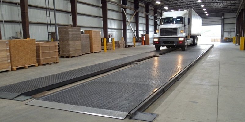 Floor Scale for Truck Weighing A floor scale installed in a warehouse with a truck driving onto it.