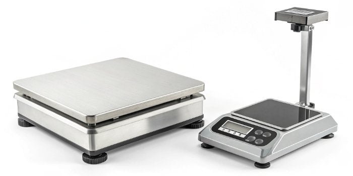 a high-quality industrial digital scale next to a cheaper commercial scale