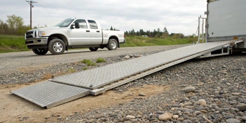 Portable Axle Scale for Shipping A portable axle scale being used on a gravel lot next to a truck.
