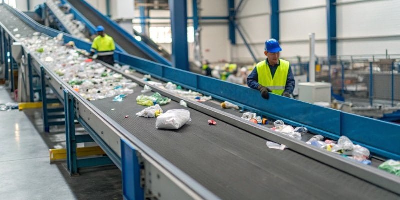 Automated Sorting Systems in Recycling An automated sorting conveyor belt in a recycling plant