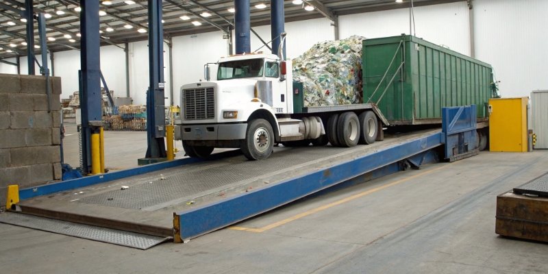 Truck Scale at Recycling Center a truck being weighed on a weighbridge at a recycling facility