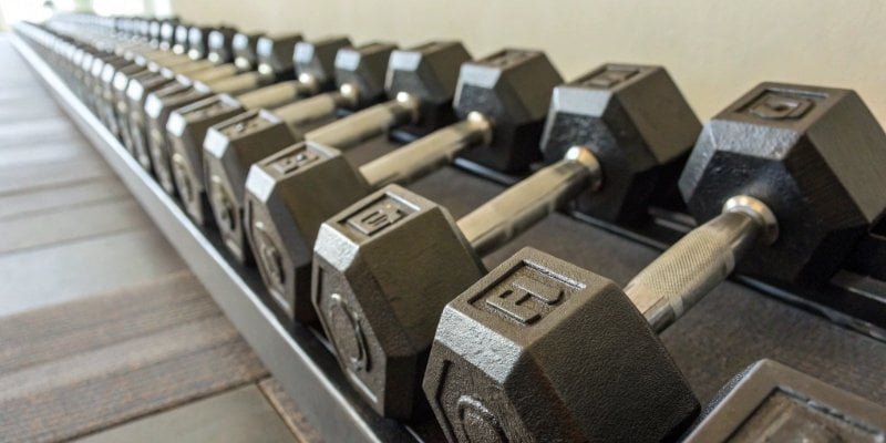 A series of certified weights lined up, representing 25%, 50%, 75%, and 100% capacity.