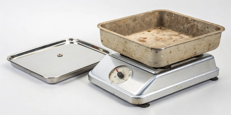 New vs Old Industrial Scale A modern, stainless steel industrial scale next to an older, worn-out model.