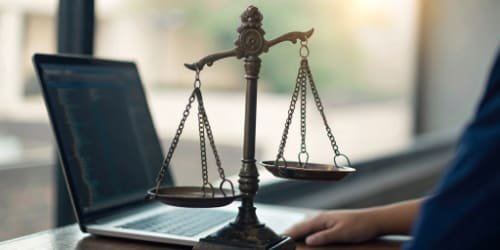 A stylized icon showing software code intertwining with a weighing scale, representing the integration of software and hardware in industrial weighing.