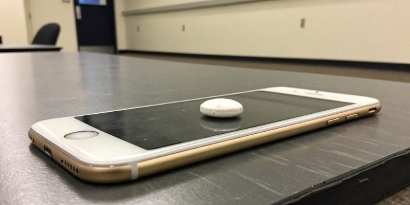 Phone acting as a weighing scale A smartphone on a table with a small object on its screen