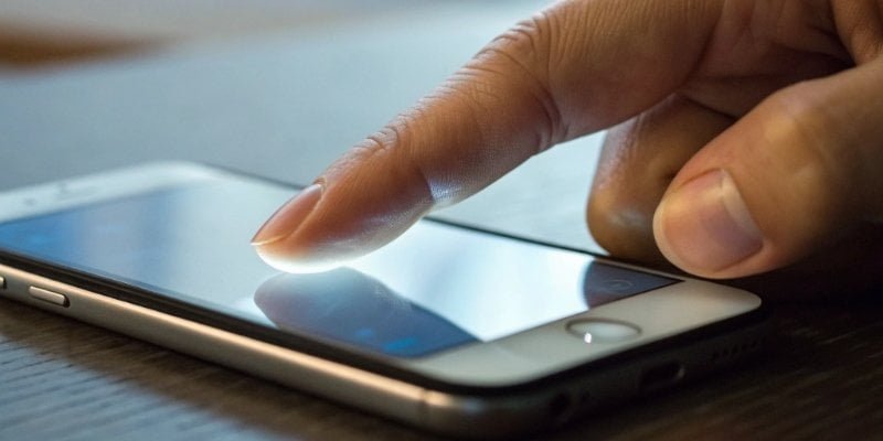 Phone's pressure-sensitive screen A close-up of a finger pressing on a smartphone screen, showing pressure sensitivity