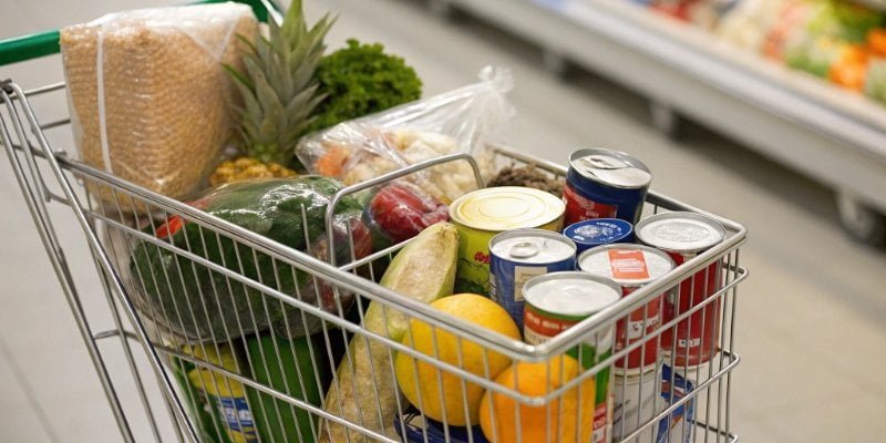 Variety of Groceries A shopping cart filled with a variety of groceries from different sections