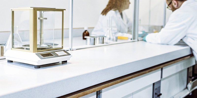 a pharmaceutical lab with a high-precision balance on a clean bench