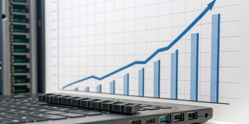 A business growth chart trending sharply upwards, with software and hardware icons at the base.