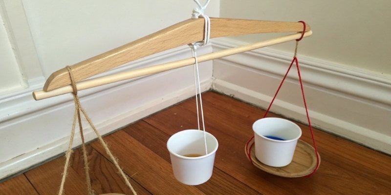 DIY balance scale A DIY balance scale made from a clothes hanger, string, and cups
