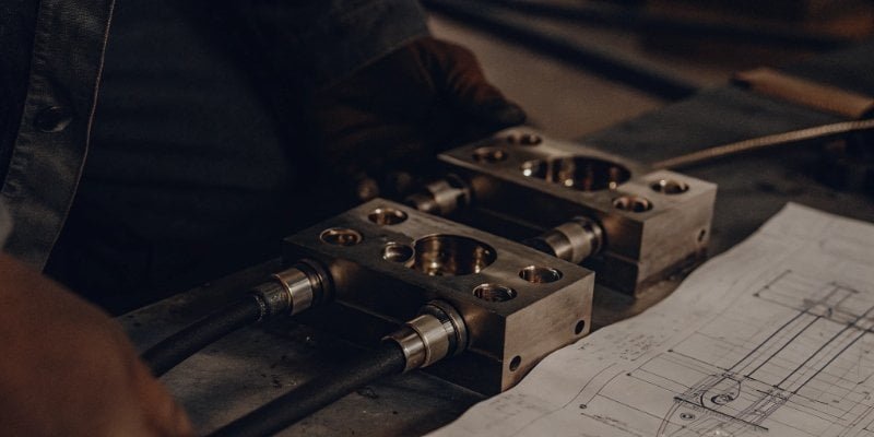 an engineer comparing two different types of load cells on a blueprint