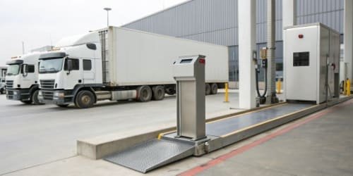 Efficient Weight Management with Scale Houses An automated, unattended weighing kiosk next to a truck scale.