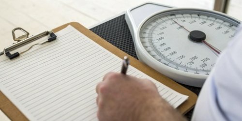 Hidden Costs of Manual Weighing A clipboard with handwritten logs next to a scale, showing potential for errors