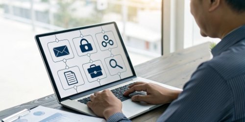 An illustration of a manager reviewing an audit log on a dashboard, with icons for user permissions and data backup.