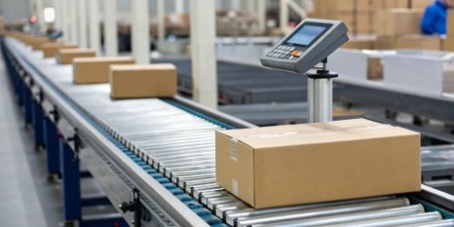 A modern label printing scale integrated into a conveyor line in an automated warehouse