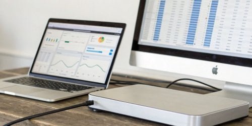 Smart Scale to Software Data Flow A smart PC scale displaying data that is being transferred to a computer screen showing software analytics.