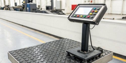 A close-up of a rugged industrial scale running a custom Android interface