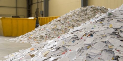 A large pile of wasted, obsolete pre-printed labels