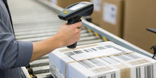 A barcode verifier device being used to scan a label from a scale