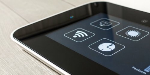 A close-up shot of a smart scale's interface, highlighting icons for Wi-Fi, CPU, and software settings