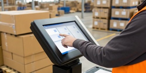 An operator using a touchscreen on a shipping scale to select a carrier.
