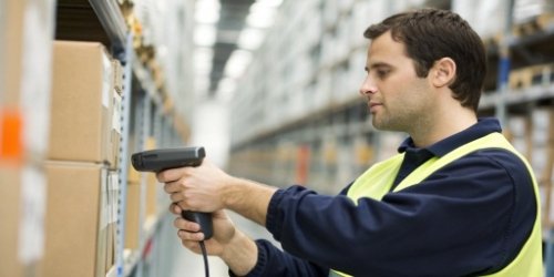 A warehouse worker scanning a custom barcode label