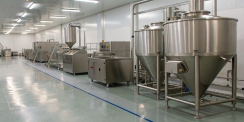 An industrial food processing line featuring various stainless steel weighing and mixing machines