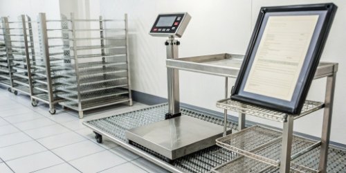 A compliance certificate next to a modern industrial scale