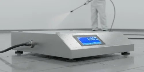 A worker easily cleaning a hygienically designed scale with smooth surfaces.