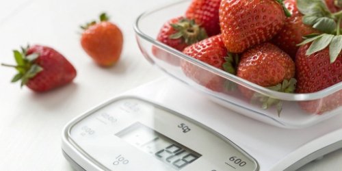 A close-up of a digital scale display showing a precise measurement for food ingredients
